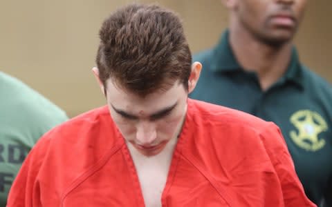 Nikolas Cruz is lead out of the courtroom after an arraignment hearing at the Broward County Courthouse in Fort Lauderdale - Credit: AP