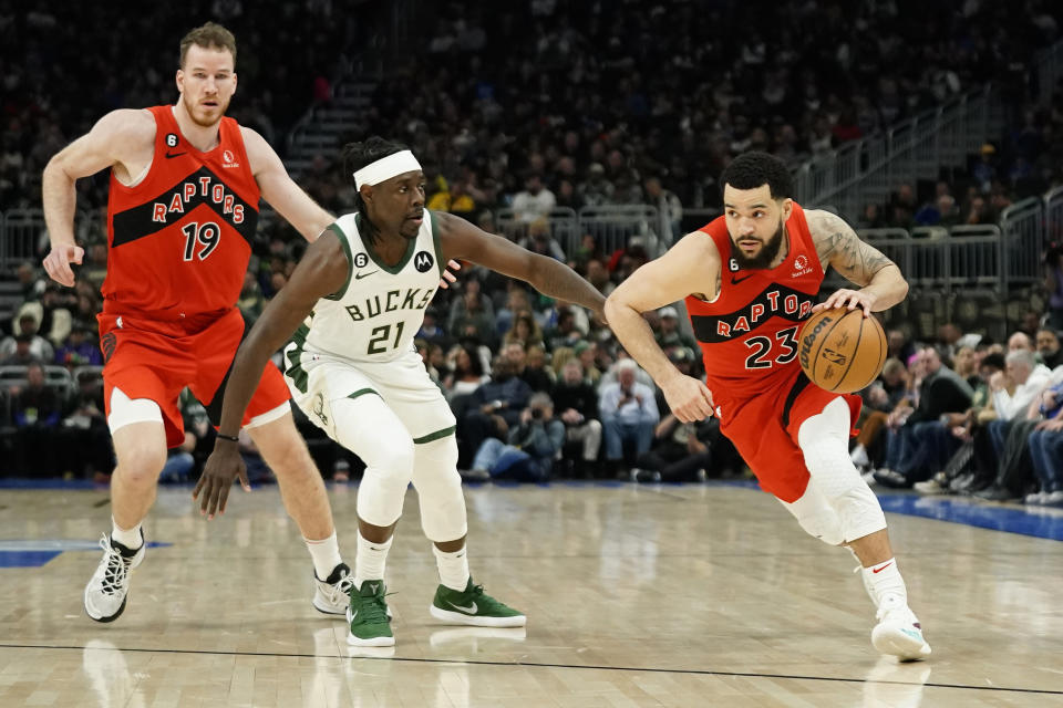 Toronto Raptors' Fred VanVleet (23) drives to the basket against Milwaukee Bucks' Jrue Holiday (21) during the first half of an NBA basketball game Sunday, March 19, 2023, in Milwaukee. (AP Photo/Aaron Gash)