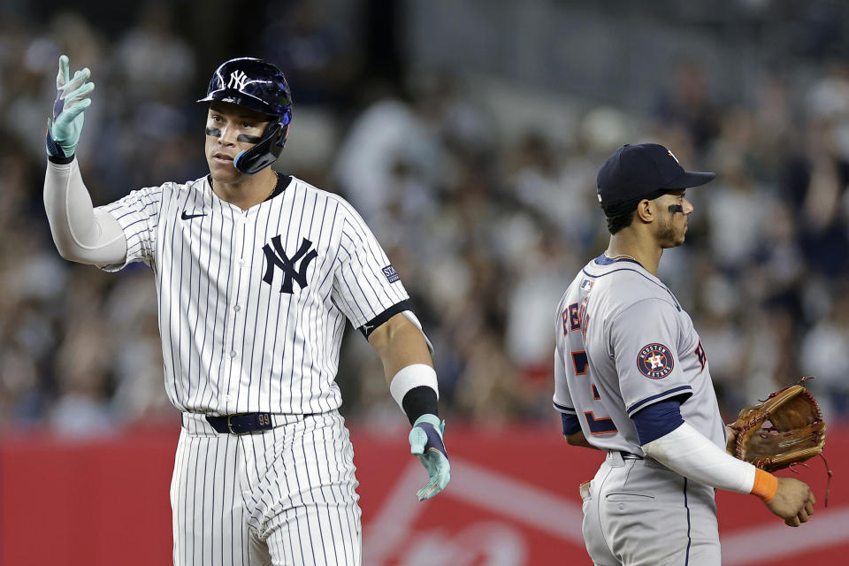 New York Yankees' Aaron Judge reacts after hitting a two-run double, next to Houston Astros shortstop Jeremy Peña during the sixth inning of a baseball game Wednesday, May 8, 2024, in New York. (AP Photo/Adam Hunger)