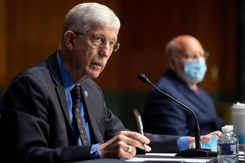 Dr. Francis Collins, left, director of the National Institutes of Health, and Dr. Robert Redfield, then the director of the Centers for Disease Control and Prevention, testify in 2020 on Capitol Hill.