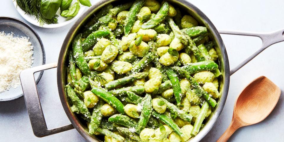 gnocchi tossed in a green sauce with asparagus