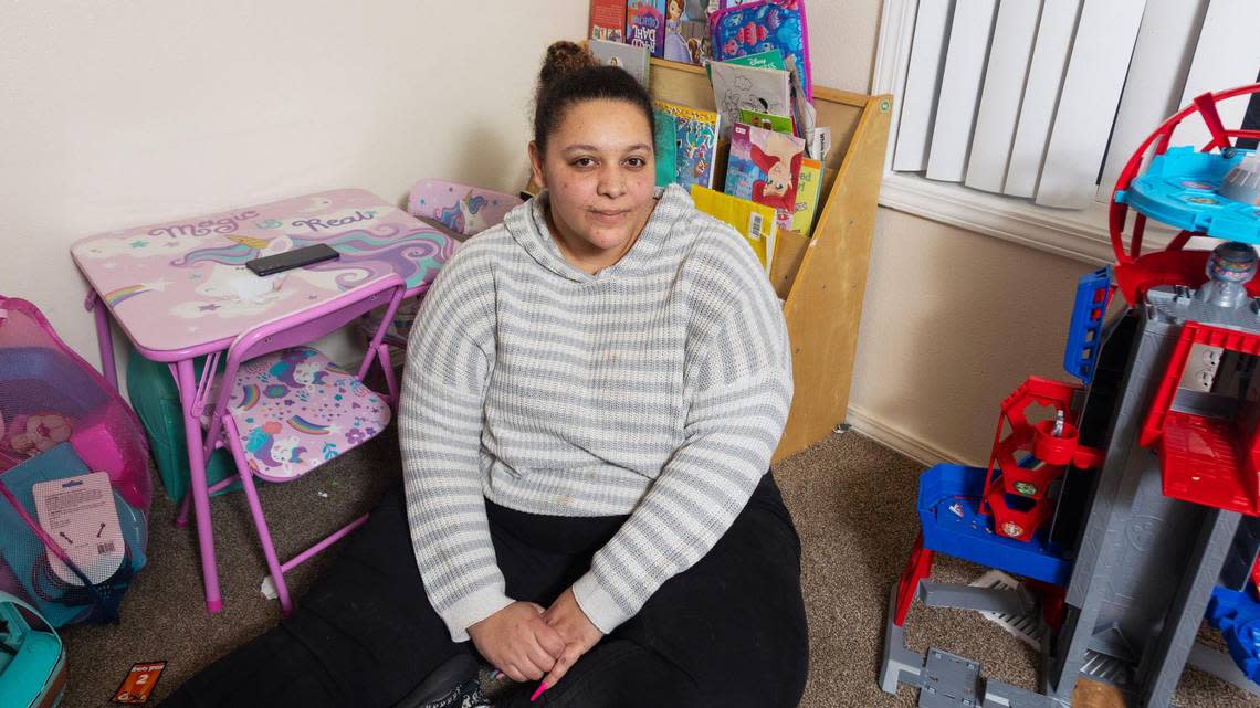 Avalon Hardy sits surrounded by her children’s toys in her Boise apartment.