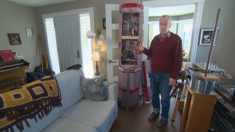 David Hunter stands next to the six-foot-tall payload of multiple computers. 