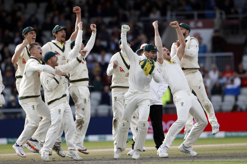 Australia players celebrate after winning the fourth test and retaining the Ashes during day five of the fourth Ashes Test cricket match between England and Australia at Old Trafford in Manchester, England, Sunday Sept. 8, 2019. (AP Photo/Rui Vieira)