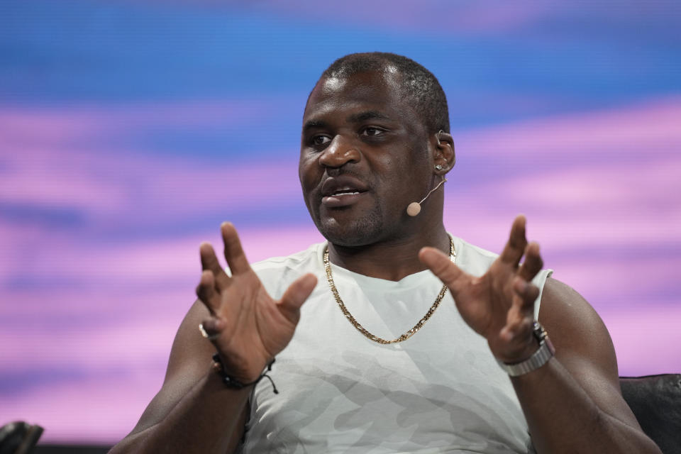 FILE - Cameroonian mixed martial artist Francis Ngannou speaks during a panel at the Bitcoin Conference, Thursday, April 7, 2022, in Miami Beach, Fla. Ngannou's reign as one of the top heavyweights in MMA will continue in the Professional Fighters League following the former champion’s contentious split with UFC. Ngannou was still UFC heavyweight champion when contract talks collapsed once the African fighter said his demands for health insurance and personal sponsorships were rejected. UFC President Dana White stripped Ngannou of the belt in January. (AP Photo/Rebecca Blackwell, File)