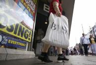 A shopper holds a BHS bag in London, Britain July 25, 2016. REUTERS/Neil Hall