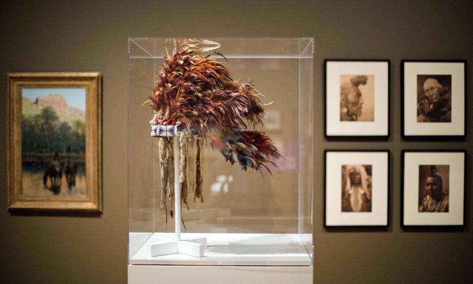 FILE - A Native American feather bonnet from 1890 made of eagle feathers, rooster hackles, wood rods, porcupine hair, wool cloth, felt, and glass beads, is displayed as part of the exhibition, "Go West! Art of the American Frontier from the Buffalo Bill Center of the West," at the High Museum of Art on Oct. 31, 2013, in Atlanta. Federal penalties have increased under a newly signed law Wednesday, Dec. 21, 2022, intended to protect the cultural patrimony of Native American tribes. (AP Photo/David Goldman, File)