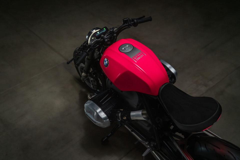 a red motorcycle parked on a concrete floor