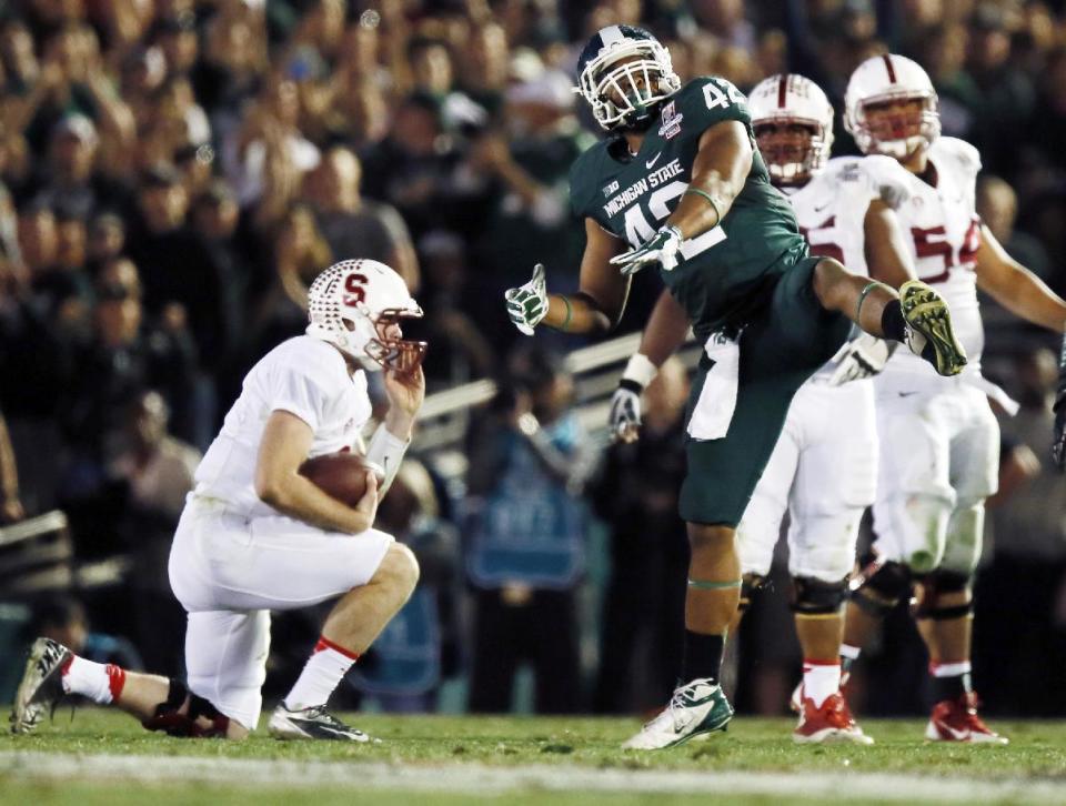 Michigan State defensive end Denzel Drone celebrates after sacking Stanford quarterback Kevin Hogan during the second half of the Rose Bowl NCAA college football game on Wednesday, Jan. 1, 2014, in Pasadena, Calif. (AP Photo/Danny Moloshok)