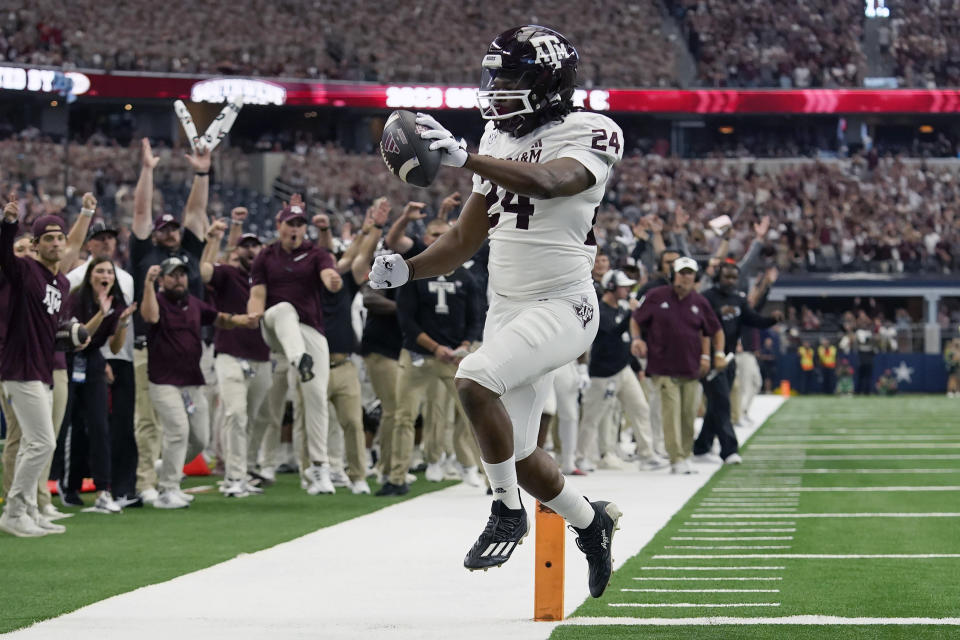 Texas A&M running back Earnest Crownover runs for a touchdown during the first half of an NCAA college football game against Arkansas, Saturday, Sept. 30, 2023, in Arlington, Texas. (AP Photo/LM Otero)