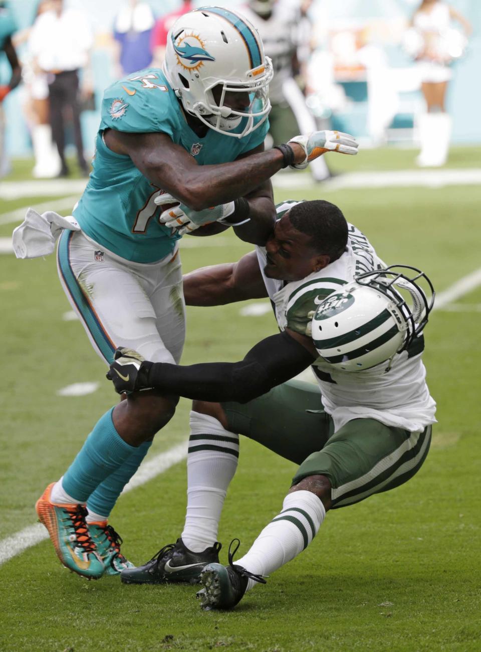 <p>Miami Dolphins wide receiver Jarvis Landry (14) runs the ball as New York Jets free safety Marcus Gilchrist (21), attempts to make the tackle, during the first half of an NFL football game, Sunday, Nov. 6, 2016, in Miami Gardens, Fla. (AP Photo/Wilfredo Lee) </p>