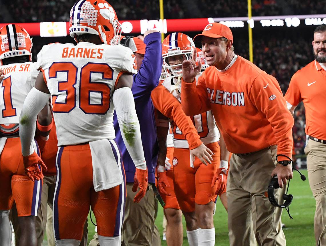 Clemson Tigers head coach Dabo Swinney celebrates with safety Khalil Barnes (36) after Clemson touchdown against the South Carolina Gamecocks during the first quarter at Williams-Brice Stadium.