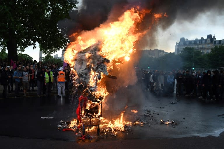 Demonstrators burned an effigy of President Emmanuel Macron during the protests in Paris on Tuesday