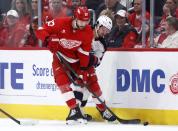 Columbus Blue Jackets center Alexandre Texier (42) tries to tie up Detroit Red Wings center Michael Rasmussen (27) during the first period of an NHL hockey game Tuesday, March 19, 2024, in Detroit. (AP Photo/Duane Burleson)