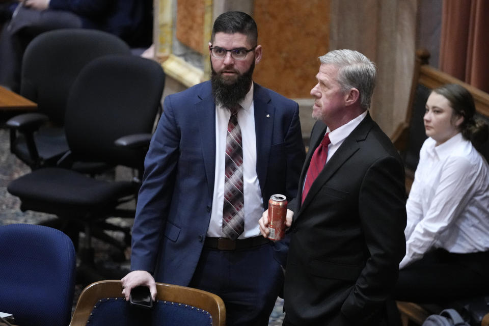 Iowa House Majority Leader Matt W. Windschitl, left, talks with State Sen. Brad Zaun, R-Polk, during debate on a bill that would create education savings accounts, Monday, Jan. 23, 2023, at the Statehouse in Des Moines, Iowa. (AP Photo/Charlie Neibergall)