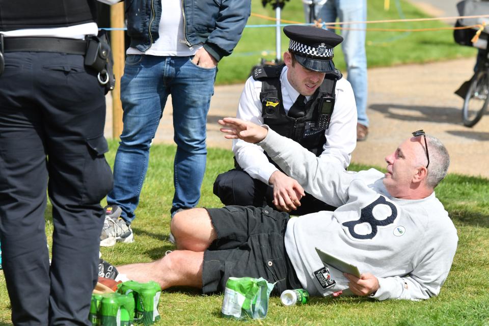 Police officers disperse people who are gathered in Hyde Park in London on May 16, 2020, following an easing of lockdown rules in England during the novel coronavirus COVID-19 pandemic. - People are being asked to 