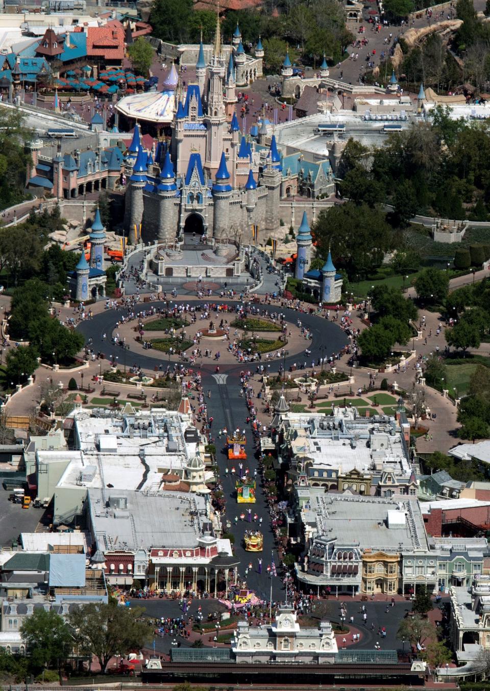 Guests line up to watch a parade along Main Street at Disney's Magic Kingdom on the final day before closing in an effort to combat the spread of coronavirus disease (COVID-19), in an aerial view in Orlando, Florida, U.S. March 15, 2020. Picture taken March 15, 2020.  REUTERS/Gregg Newton