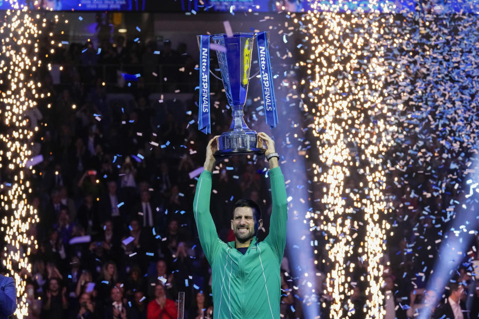 Serbia's Novak Djokovic celebrates with the trophy after winning the singles final tennis match of the ATP World Tour Finals at the Pala Alpitour, in Turin, Italy, Sunday, Nov. 19, 2023. (AP Photo/Antonio Calanni)