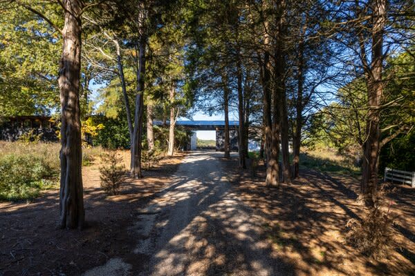 Nestled among lush landscaping, far from the street, the home presents an idyllic retreat.