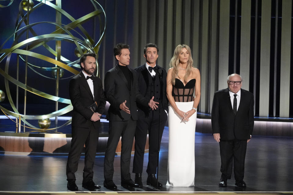 Charlie Day, from left, Glenn Howerton, Rob McElhenney, Kaitlin Olson, and Danny DeVito present the award for outstanding variety talk series during the 75th Primetime Emmy Awards on Monday, Jan. 15, 2024, at the Peacock Theater in Los Angeles. (AP Photo/Chris Pizzello)