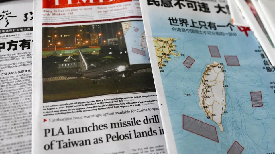 A map showing locations where Chinese People's Liberation Army (PLA) will conduct military exercises and training activities including live-fire drills is seen on newspaper reports of U.S. House of Representatives Speaker Nancy Pelosi's visit to Taiwan