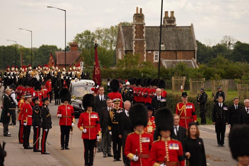 A procession joins the hearse on the final part of the Queen’s journey to Windsor Castle (PA)