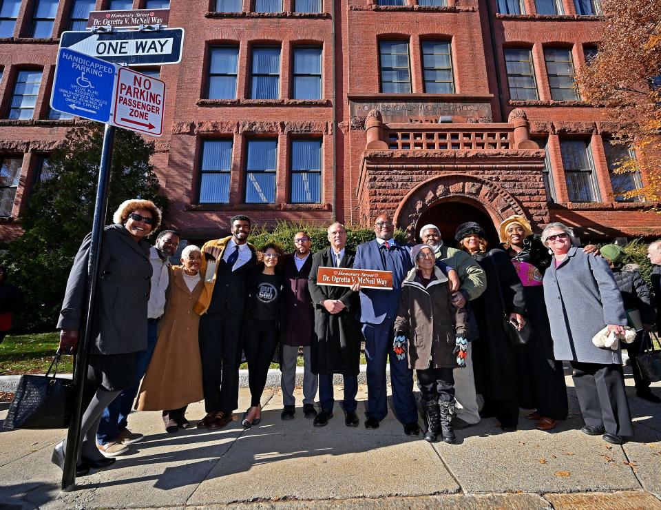 City officials, friends and family members unveil the honorary street sign to Dr. Ogretta V. McNeil Monday.