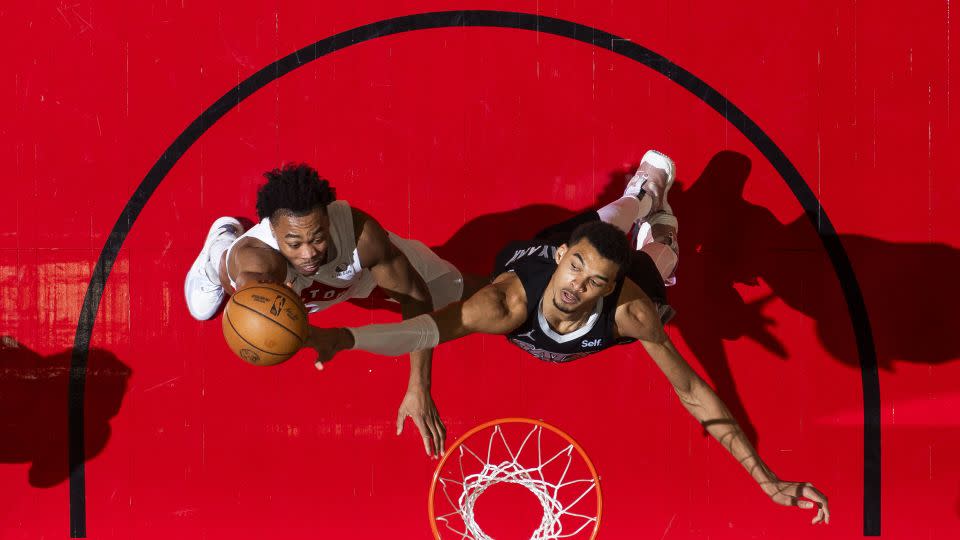 Wembanyama denies Toronto's Scottie Barnes at the rim during the game. - Mark Blinch/NBAE/Getty Images