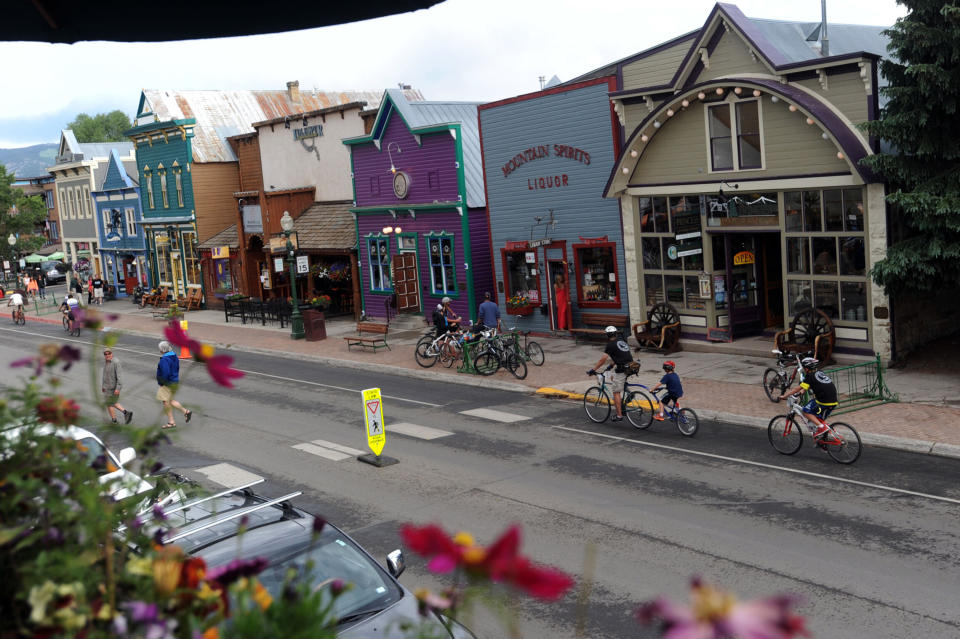 In this June 29, 2013 photo, cyclists ride down Elk Avenue during the Bridges of the Butte 24-Hour Townie Tour as part of the annual Bike Week in Crested Butte, Gunnison, County, Colo. When the small county in the Colorado mountains banished everyone but locals to blunt the spread of coronavirus, an unlikely outsider raised a fuss: Texas Attorney General Ken Paxton, who called it an affront on Texans who own property there and pressed health officials to soften the rules. (Christian Murdock/The Gazette via AP)