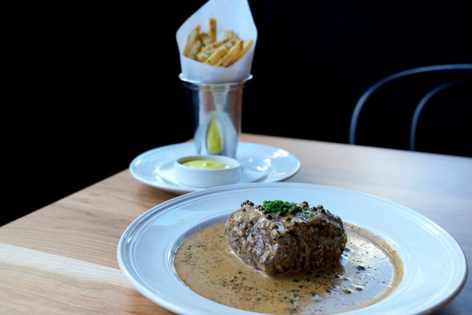 The Davidson's steak frites features a filet medallion, cognac au poivre and fries with bearnaise aioli.