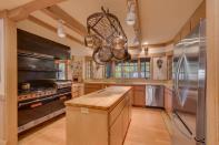 The kitchen features a huge cooking space and wooden cabinets and bench tops. Photo: IMP/australscope