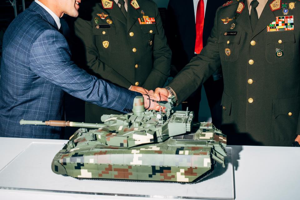 Peruvian delegation at the stand of UkrOboronProm shaking hands