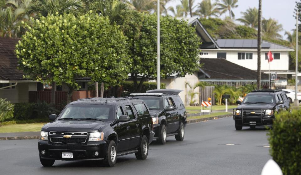 A motorcade with President Barack Obama and first lady Michelle Obama aboard leaves the Kailua, Hawaii, neighborhood were the first family is staying during their annual family vacation, Sunday, Dec. 18, 2016, en route to an outing at Ho'omaluhia Botanical Garden in Kaneohe, Hawaii. (AP Photo/Carolyn Kaster)