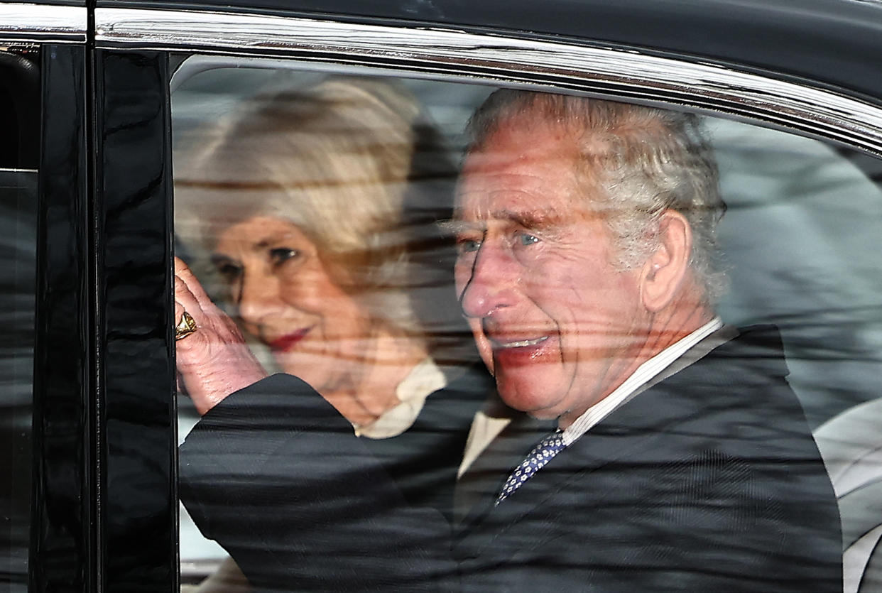 Britain's King Charles III and Britain's Queen Camilla wave as they leave by car from Clarence House in London on February 6, 2024. King Charles III's estranged son Prince Harry reportedly arrived in London on Tuesday after his father's diagnosis of cancer, which doctors 