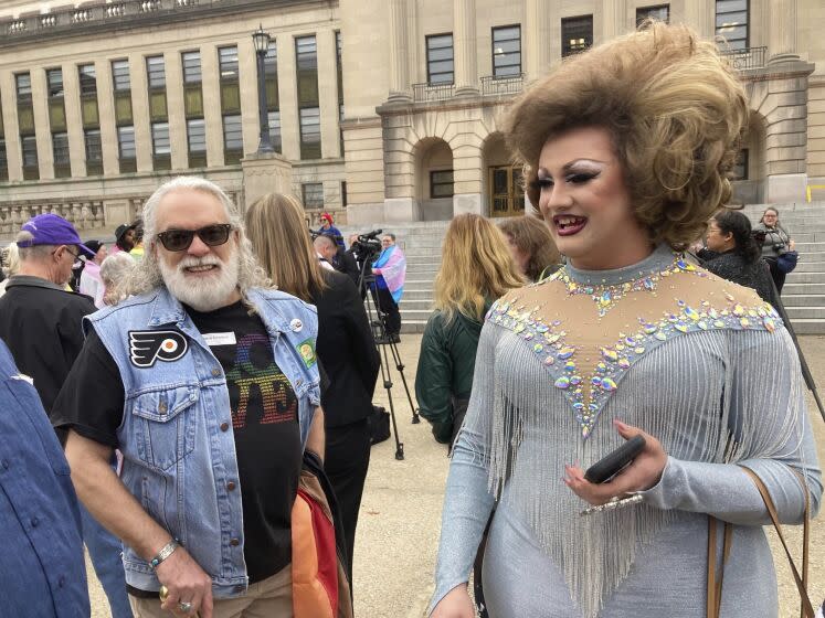 Drag performer Poly Tics, right, attends a rally in Frankfort, Ky., on Thursday, March 2, 2023. She spoke earlier at a legislative committee hearing where she opposed a bill that would put limits on drag shows in Kentucky. (AP Photo/Bruce Schreiner)