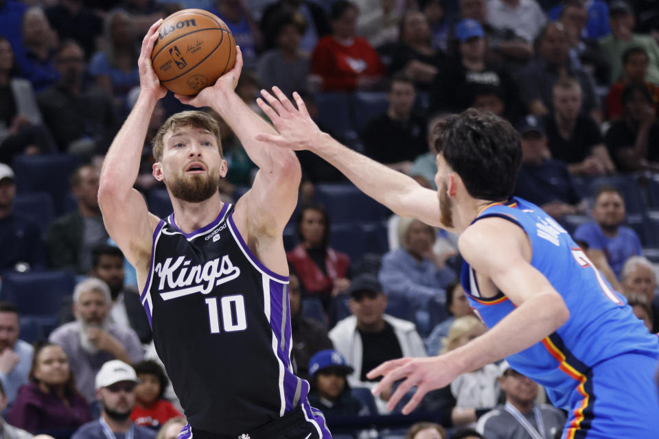 Sacramento Kings forward Domantas Sabonis (10) prepares to shoot against Oklahoma City Thunder forward Chet Holmgren during the first half of an NBA basketball game Tuesday, April 9, 2024, in Oklahoma City. (AP Photo/Nate Billings)