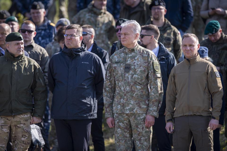 From left, Chief of the General Staff of the Polish Armed Forces Gen. Wieslaw Kukula, Lithuanian Defense Minister Laurynas Kasciunas, Lithuania's President Gitanas Nauseda and Poland's President Andrej Duda to watch a Lithuanian-Polish Brave Griffin 24/II military exercise near the Suwalki Gap near the Polish border at the Dirmiskes village, Alytus district west of the capital Vilnius in Lithuania on Friday, April 26, 2024. Over 1500 troops and 200 pieces of tactical equipment are rehearsing defence scenarios under the bilateral Lithuanian-Polish Orsha Plan near the Suwalki Gap. (AP Photo/Mindaugas Kulbis)