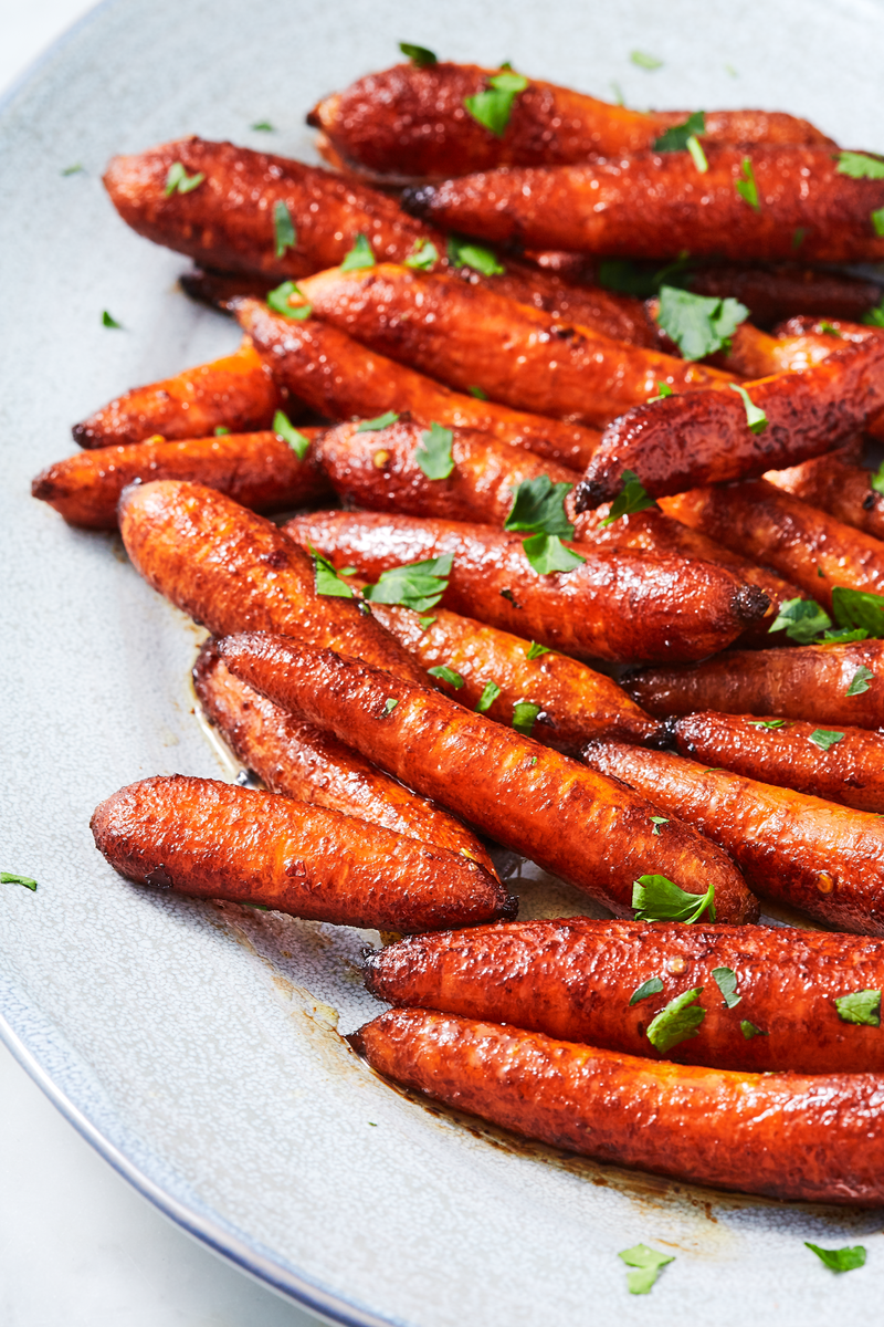 <p>Sometimes we find ourselves with a bag of baby carrots and we aren't sure what to do with them. This is what we should do. Roasting baby carrots in a maple-balsamic glaze will turn everyone into a carrot lover!</p><p>Get the <a href="https://www.delish.com/uk/cooking/recipes/a31011761/roasted-baby-carrots-recipe/" rel="nofollow noopener" target="_blank" data-ylk="slk:Balsamic Roasted Baby Carrots;elm:context_link;itc:0;sec:content-canvas" class="link ">Balsamic Roasted Baby Carrots</a> recipe.</p>