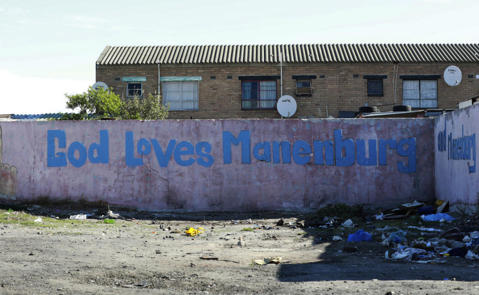 In this May 2, 2020, photo, a wall is covered in graffiti in the Manenberg neighborhood of Cape Town, South Africa. A preacher recruited members of street gangs to distribute food in a violent and poor neighborhood during the coronavirus lockdown. (AP Photo/Nardus Engelbrecht)