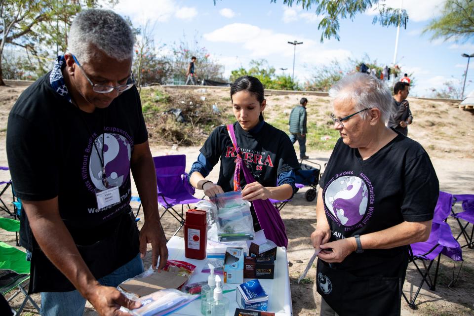 Volunteers with Acupuncturists Without Borders Victor Manuel, Rocio Lopez and Paula Burgess, set up an acupuncture area inside the migrant camp in Matamoros, Tamaulipas along the U.S. border.