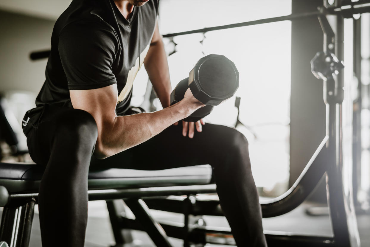 Lifting weights is a great way to keep your belly fat under control. (Getty Images)