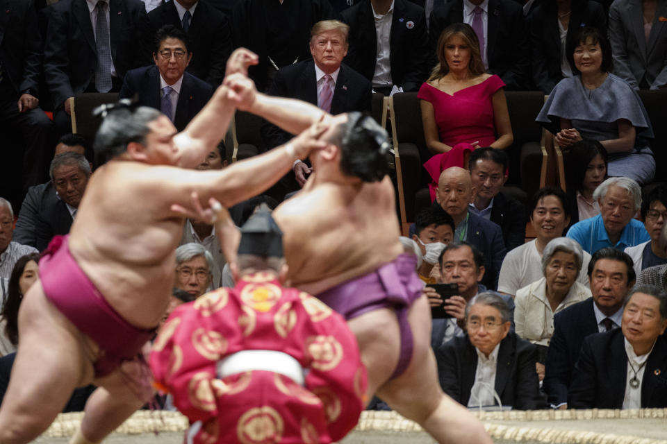 President Donald Trump attends the Tokyo Grand Sumo Tournament with Japanese Prime Minister Shinzo Abe at Ryogoku Kokugikan Stadium, Sunday, May 26, 2019, in Tokyo. At top right is Akie Abe and second from right is first lady Melania Trump. (AP Photo/Evan Vucci)