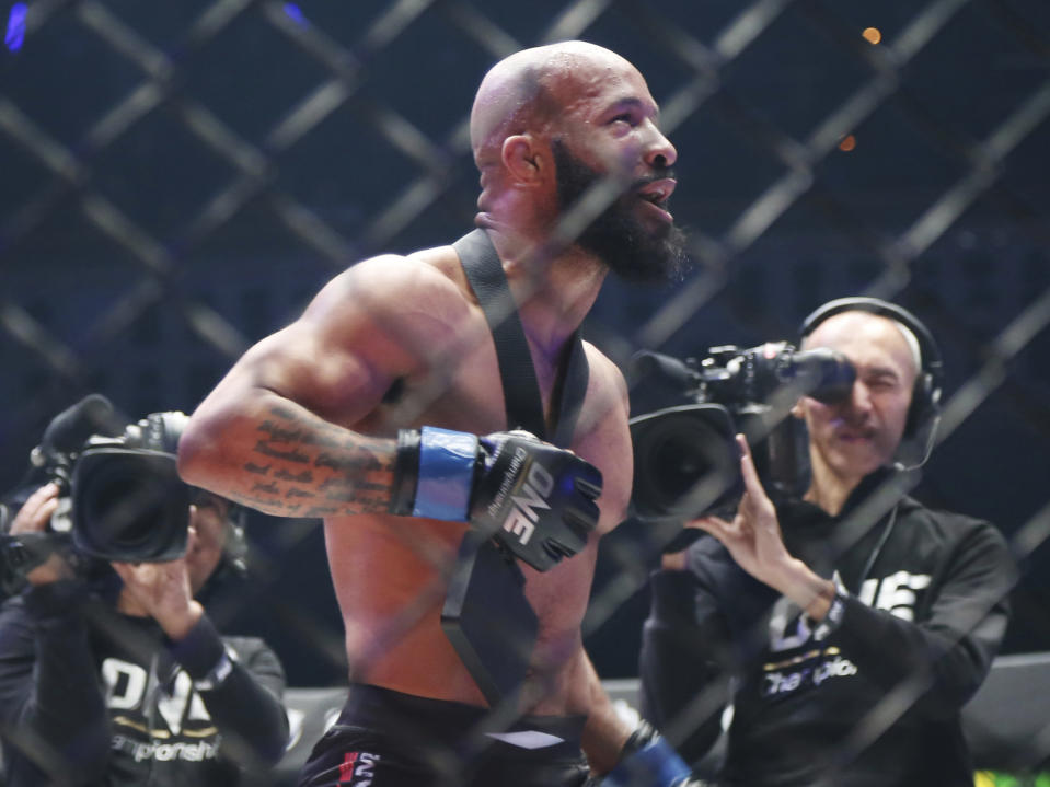 FILE - Mixed Martial Arts fighter Demetrious Johnson celebrates after defeating Japan's Yuya Wakamatsu in a flyweight world grand prix quarterfinal One Championship bout in Tokyo, in this Sunday, March 31, 2019, file photo. Demetrious Johnson and Eddie Alvarez won UFC championships before leaving their native U.S. to pursue another title overseas. Their home fans will get to see their next fights in Singapore thanks to One Championship's new series of fight cards on TNT. (AP Photo/Koji Sasahara, File)