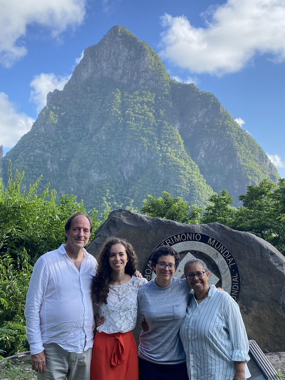 the author with her family posing in st lucia in front of a mountain