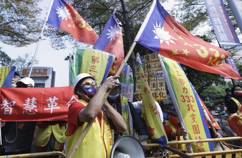 Pro-China protesters shout slogans outside of the hotel where former U.S. Secretary of State Mike Pompeo will deliver a speech in Taipei, Taiwan, Friday, March 4, 2022. (AP Photo/Chiang Ying-ying)