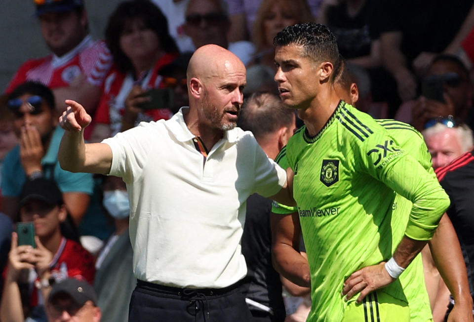 From left to right, Manchester United manager Erik ten Hag speaking with Cristiano Ronaldo during an English Premier League game in 2022. 