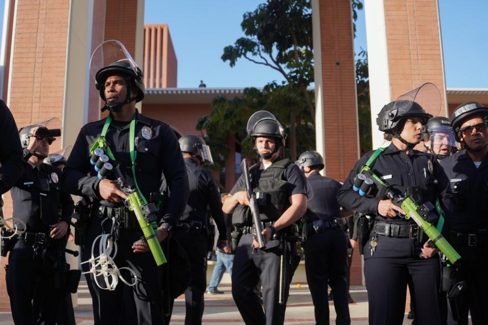 LAPD officers stand guard at the pro-Palestine protest at the University of Southern California on April 24. <span class="copyright">Joy Wang for Daily Trojan</span>