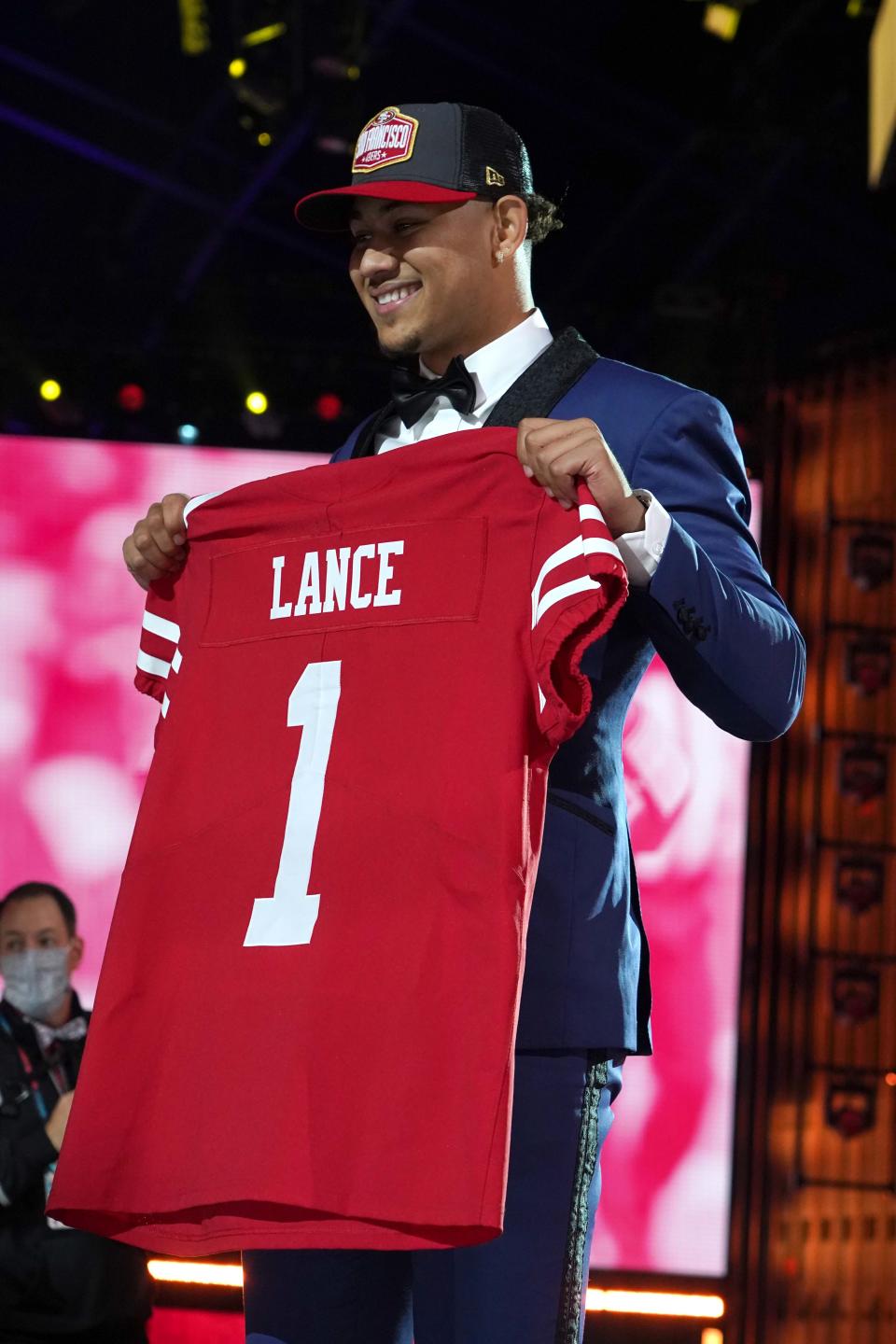 Trey Lance poses with a jersey after being selected as the third pick by the San Francisco 49ers.