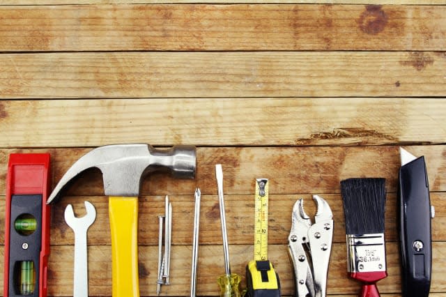 Closeup of assorted work tools on wood