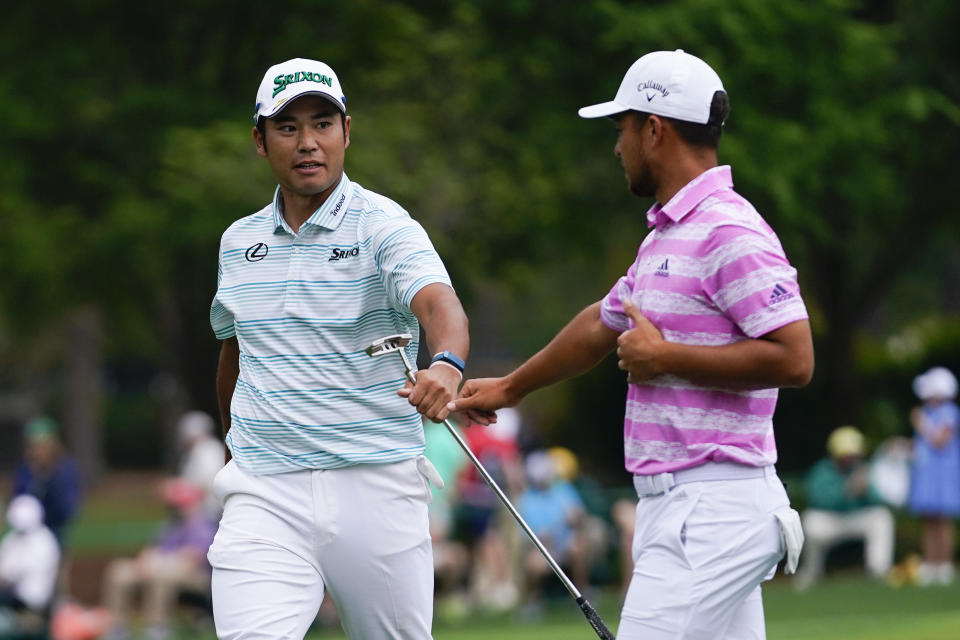 FILE - Hideki Matsuyama, of Japan, and Xander Schauffele, right, congratulate themselves after their eagles on the 15th hole during the third round of the Masters golf tournament on Saturday, April 10, 2021, in Augusta, Ga. Matsuyama's 5-iron was one of the key shots of the Masters in his historic victory. (AP Photo/Matt Slocum, File)